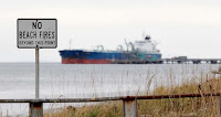 In this Oct. 23, 2012, file photo, a ship is moored at a BP oil refinery in the Strait of Georgia just beyond the location of a proposed coal exporting terminal in Ferndale, Wash. The U.S. Army Corps of Engineers on Monday, May 9, 2016, denied a permit to a $700 million project to build the nation's largest coal-export terminal in northwest Washington state. (Photo Credit: Elaine Thompson, AP) Click to Enlarge.