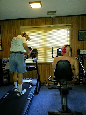 father and son both exercise and listen to music together