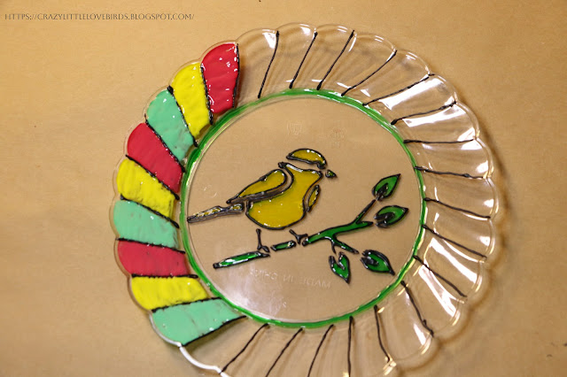 Painted plastic plate with yellow, red and green and bird design