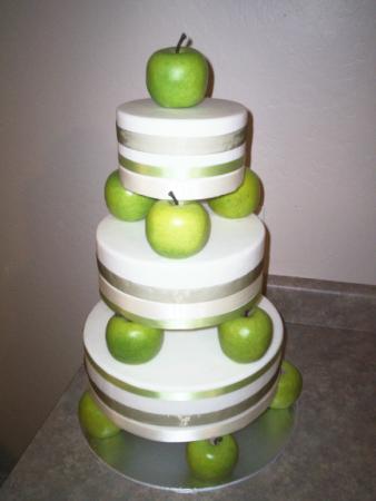 Fondant covered three tier wedding cake with green and cream ribbon