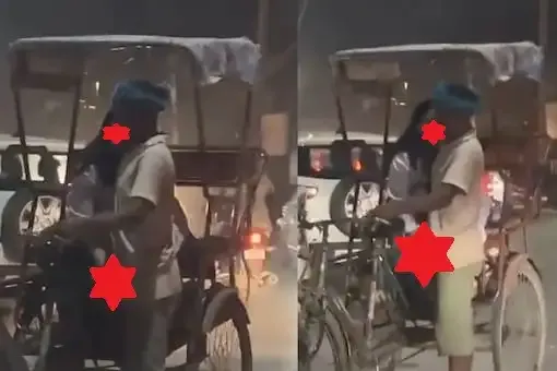 Woman touching rickshaw puller on busy road.