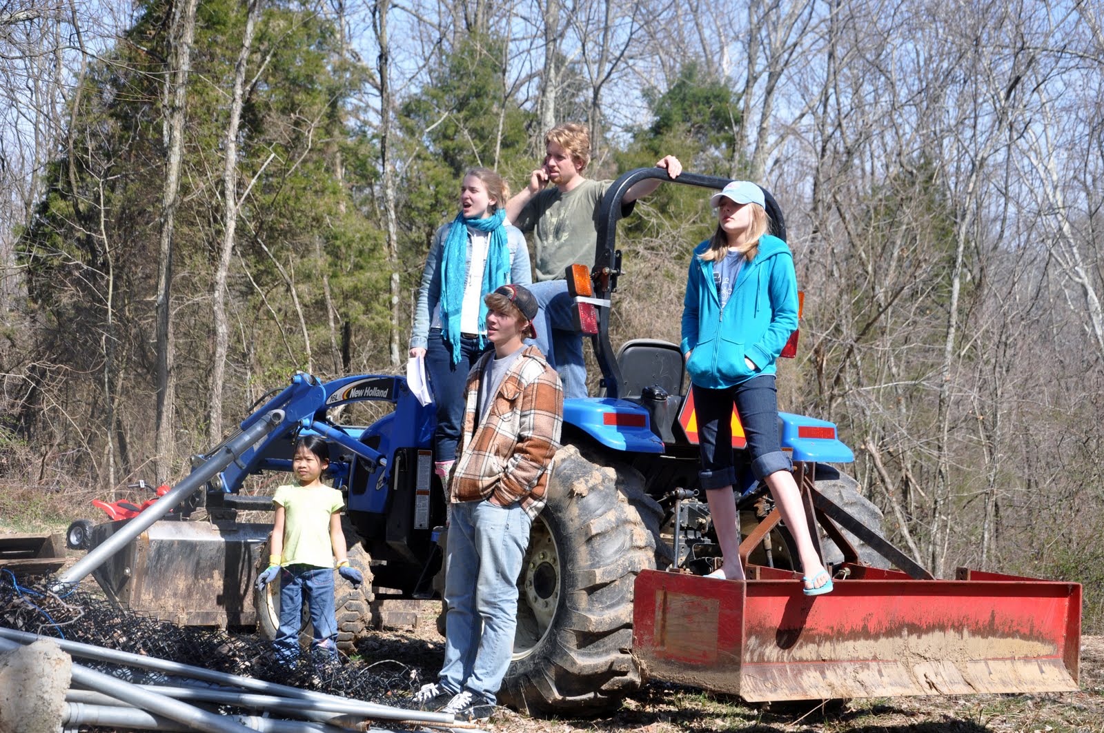 Cheering their Daddy on as he digs out a stump and root system.