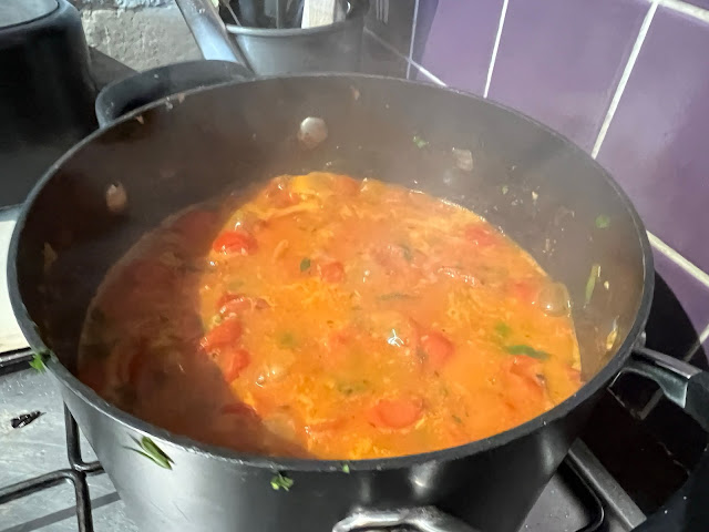 A saucepan full of cooking cherry tomatoes