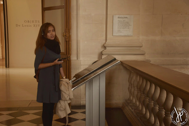 woman listening to audio guide