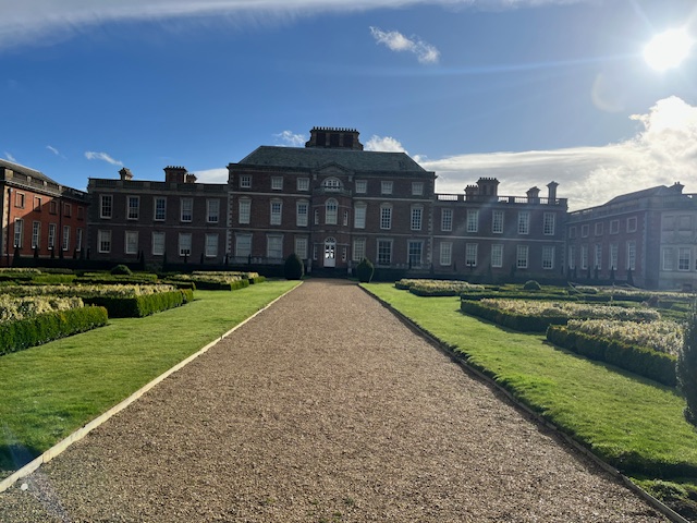 a large brick building with a path leading to the front