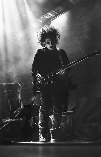 The Cure's Robert Smith playing his guitar in 1989. Photo by Jason Scott Tilley