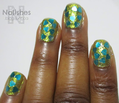 Mani using chunky teal heart glitters over a chartreuse sparkly base