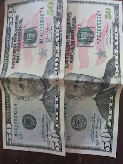 " Two 50 United States Dollar bills"