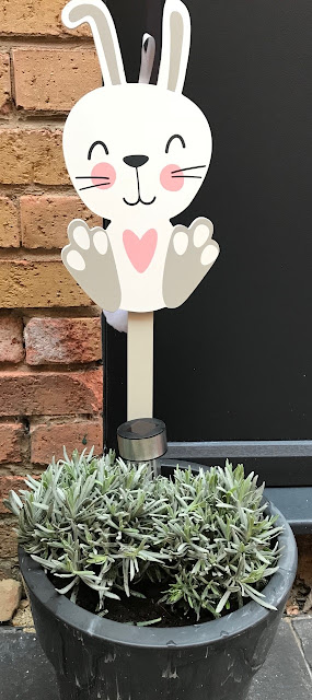 Wooden easter bunny sign in a plant pot