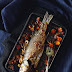 Sea bass baked in red wine sauce with vegetables