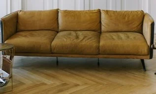 A Three-Seater Brown Leather Sofa