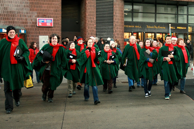 The Stairwell Carollers race across the street to carol in Byward Market