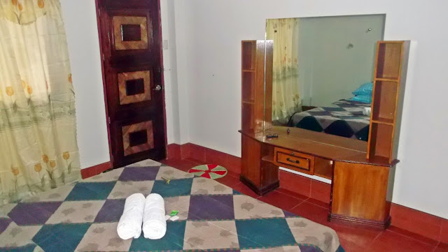 view of the dresser and entrance door from the bed of a room in Haven of Fun Resort in San Antonio, Dalupiri Island, Northern Samar