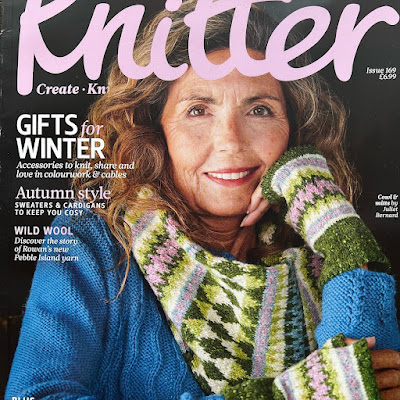 Model wearing hand knitted garments smiling at camera