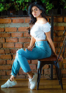 esha rebba in blue jeans and white top with white sports shoes