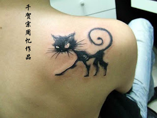 Very cool cat tattoo.