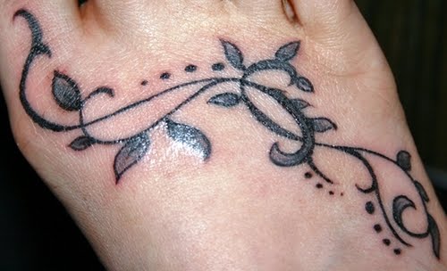Flower foot tattoo idea for women. Shooting stars foot tattoo for women.