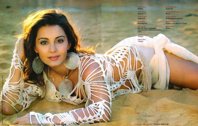 Manisha lying on beach in a bikini