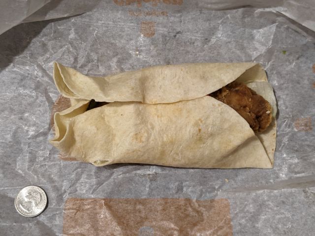 Burger King Honey Mustard BK Royal Crispy Wrap with quarter for size comparison.