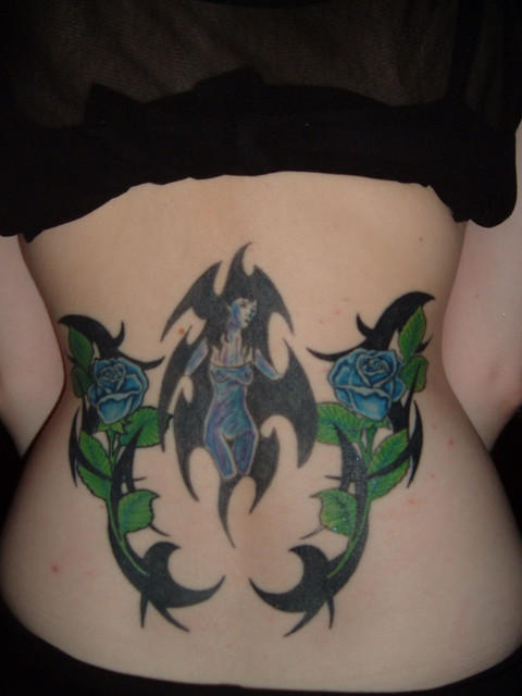 organic plant like tribal tattoo on hips and lower back