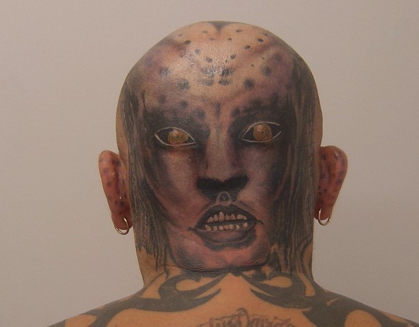 Cat man face head tattoo.