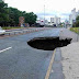 Heavy Rain Leaves Open Hole On Road In Manchester City Centre