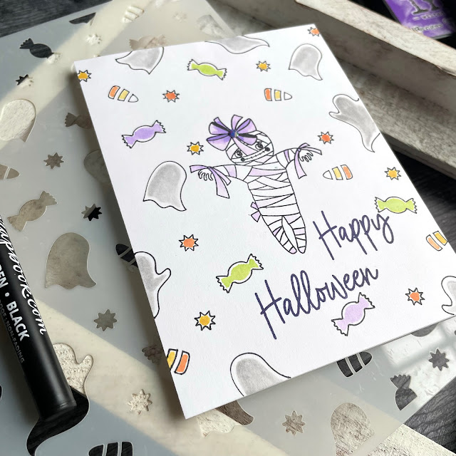 Halloween Mummy and Treats card created with: Scrapbook.com ghostly treats stencil, boo-tiful stamp set, journaling pen; Tim Holtz distress ink in fossilized amber twisted citron wilted violet crackling campfire and hickory smoke; Pinkfresh jewels