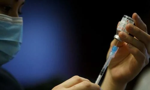 A nurse prepares a COVID-19 vaccine in Toronto, Canada, in a March 23, 2021, file photograph.