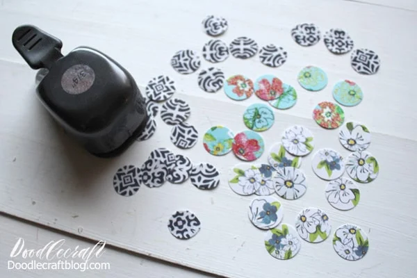 Use the circle punch or scissors to cut out the scrapbook paper. Cut out pieces that have interesting shapes. The glass gems will magnify the image on the paper beautifully.