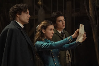 Enola Holmes 2. Henry Cavill as Sherlock Holmes, Millie Bobby Brown as Enola Holmes, Louis Partridge as Tewkesbury. Photo courtesy of Netflix