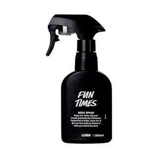 A big black spray bottle filled with orange liquid with a black domed label that says fun times body spray 200g Lush in white font on a bright background