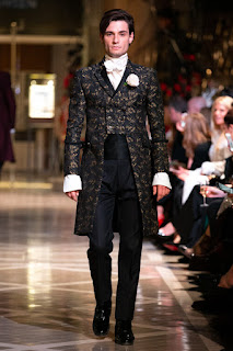 A catwalk male model in a Dandy Rebels suit by Joshua Kane