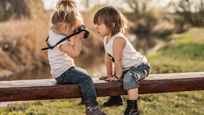 little-child-taking-photograph-of-other-baby