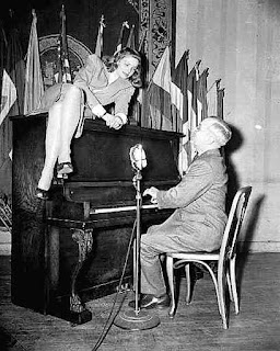 President Harry Truman plays piano to Lauren Bacall