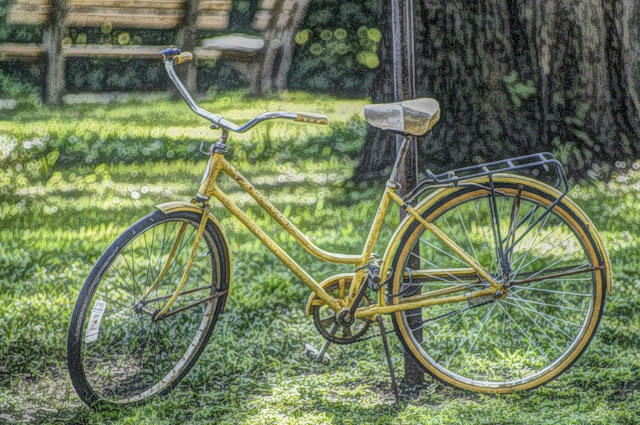 Commercial use free picture of a bicycle tied to a pole.