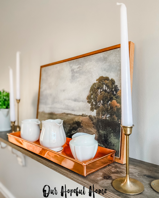 rectangular copper tray filled with ironstone creamers