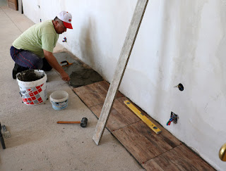 Mesut continues the tile laying process