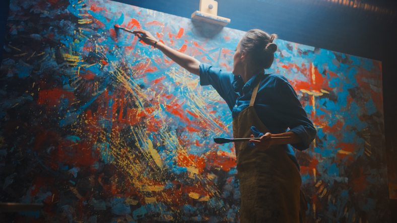 Woman painting abstract painting.