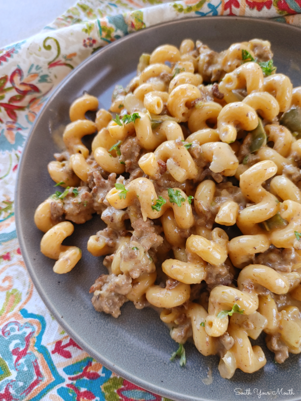 The BEST Philly Cheesesteak Pasta! A family-sized pasta recipe with seared ground beef, green bell peppers, onions and seasoned pasta folded into a velvety Philly-style cheese sauce.