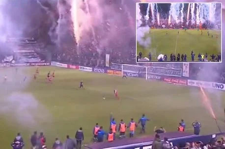 Football game looks like it's being played in a 'warzone' as fans let off fireworks