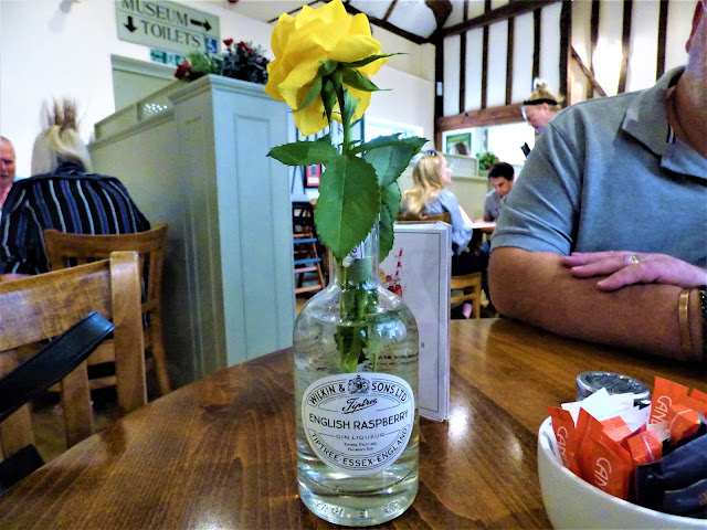 Gin liqueur bottle repurposed as a vase at Tiptree Tea Rooms in Essex