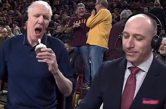 Bill Walton bites into cupcake with lit candle