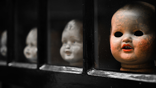 Head scary dolls in window