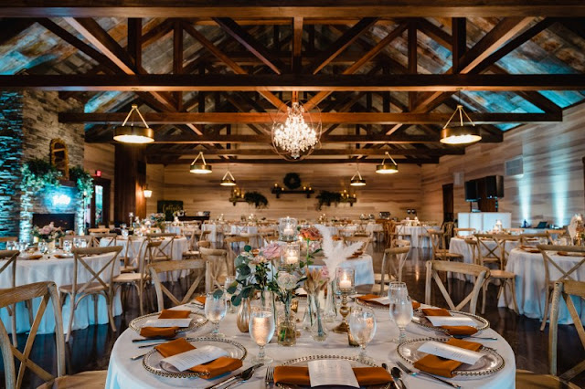 reception table setup with wooden crossback chairs and rust colored napkins