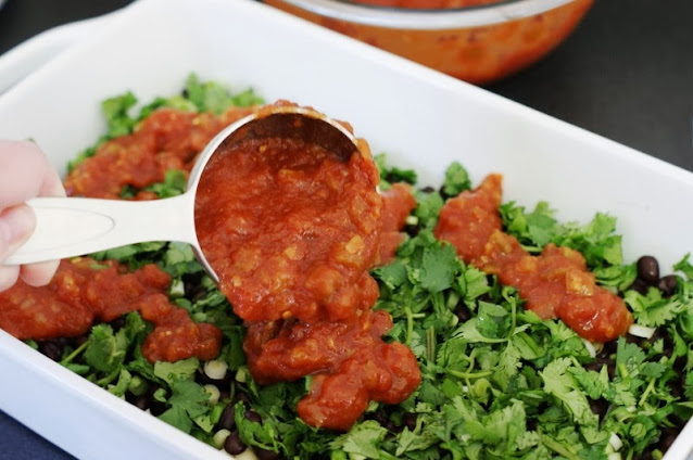 Layering Salsa in Baking Dish Image