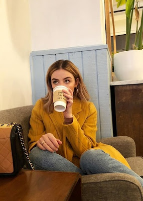 Actress Lucy Hale fall outfit. Burnt orange yellow sweater jacket