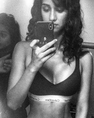 Disha Patani clicking mirror selfie in black sports bra baring her tight boobs