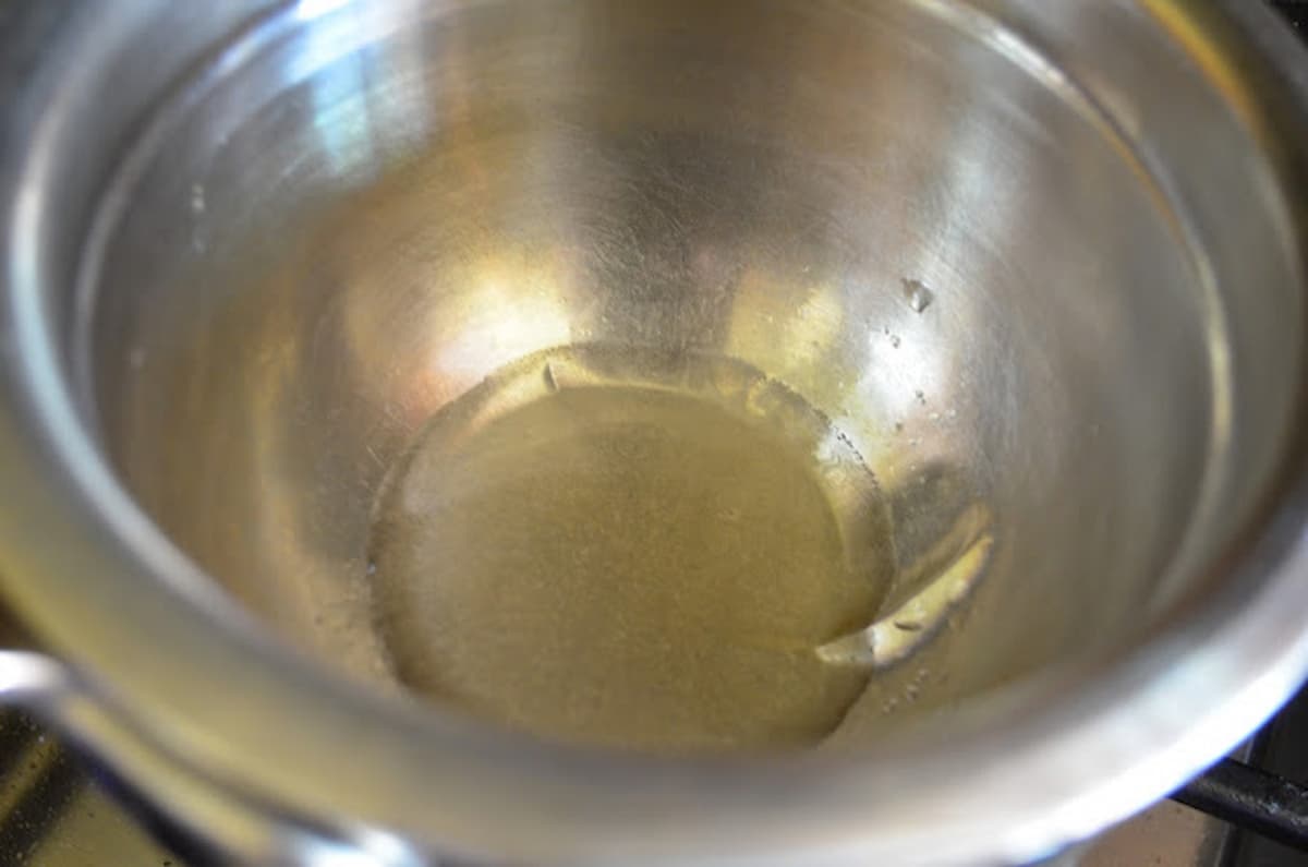 Cooked clear gelatin in a small stainless steel bowl.