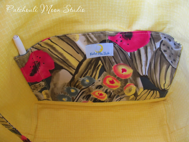 Lining of tote bag is bright yellow with cactus print slip pocket