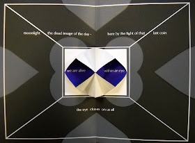 An open page of black, white, and purple shapes interspersed with text.